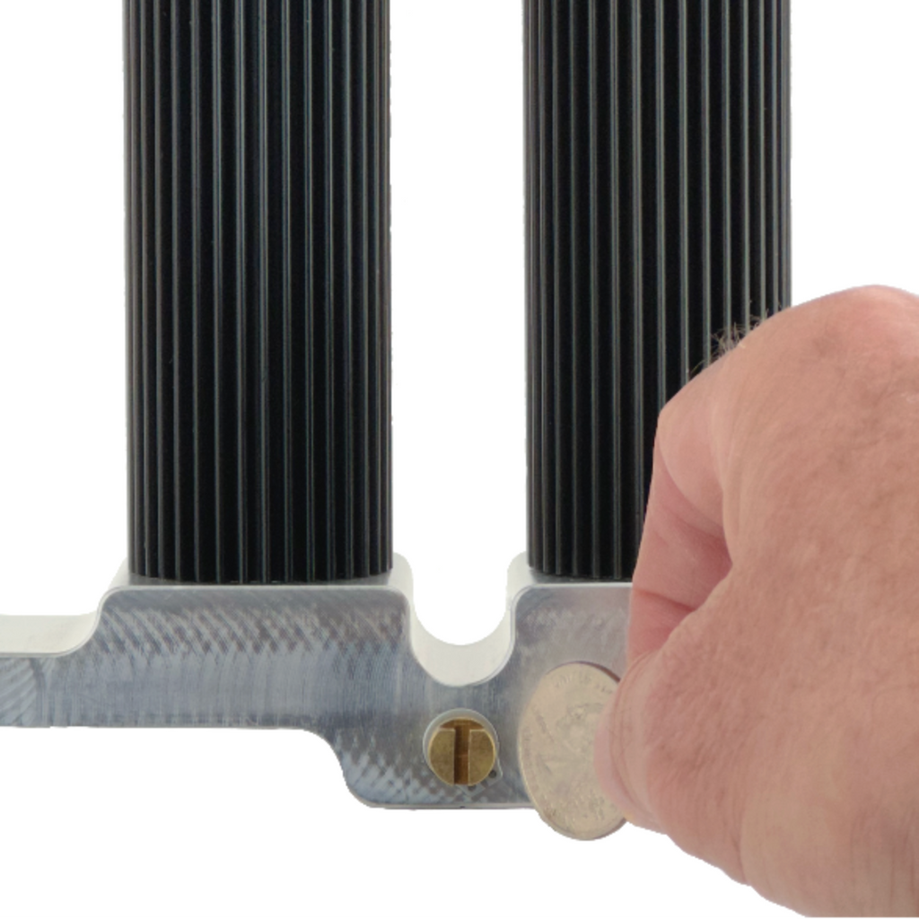 hand using coin to adjust tension on cylinders